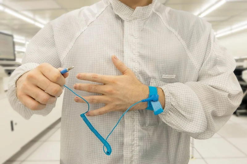 Operator adjusting ESD wrist strap onto wrist - Bondline